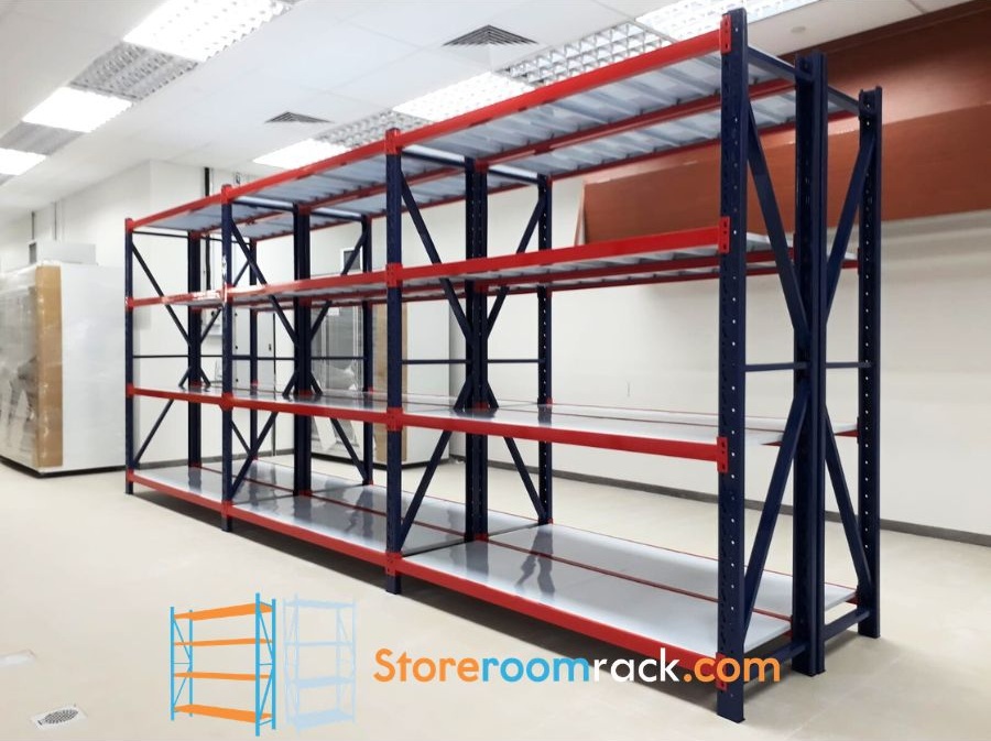 Navy and red boltless racking installed along the wall of an office storeroom under ceiling lighting